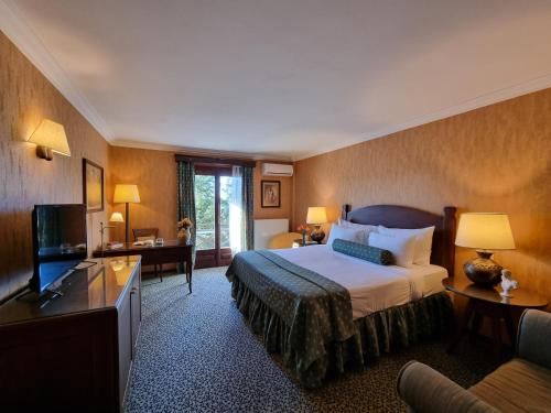 a hotel room with a bed and a television at Likoria Hotel in Arachova