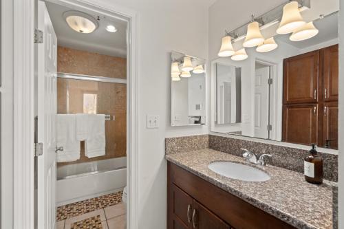 a bathroom with a sink and a mirror at Belmont Ocean Views - Massive Private Deck, Grill & Parking in San Diego