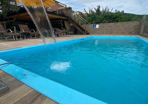 a swimming pool with a water fountain at Pousada São Miguel Beach Beira Mar in Penha
