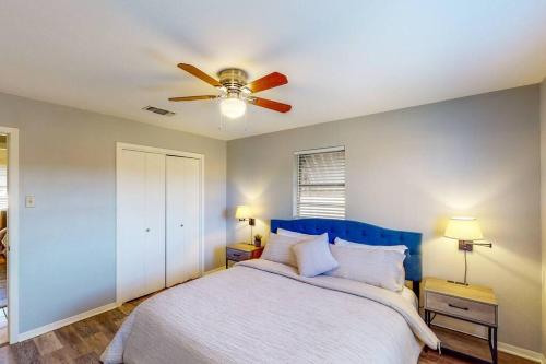 a bedroom with a bed with a ceiling fan at New Cozy Home 10 Min to Magnolia and Baylor in Waco
