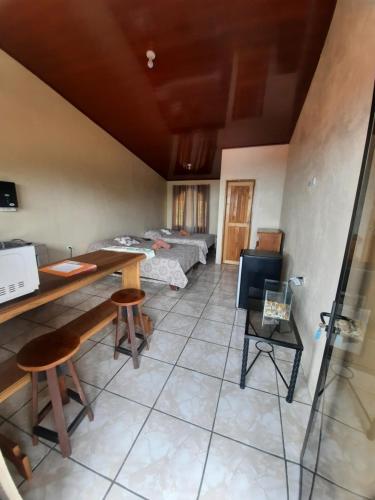 a room with two beds and a table and chairs at Ocean view in Monteverde Costa Rica