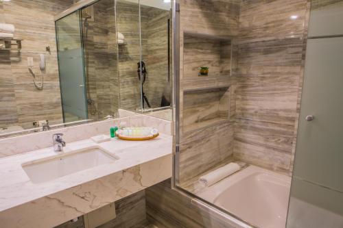 a bathroom with a sink and a tub and a shower at Jose Antonio Deluxe in Lima