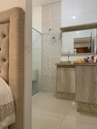 a bathroom with a sink and a shower at Casa itapema in Itapema