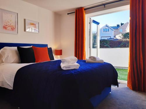 a bedroom with a bed and a large window at No's 2 and 5 Llewelyn Apartments in Llanberis