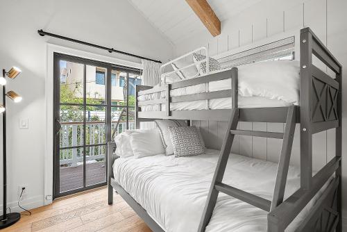 a bedroom with a bunk bed and a balcony at Neptune Experience in Encinitas