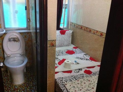 a small bathroom with a toilet and a sink at Mabuhay Hotel in Hong Kong