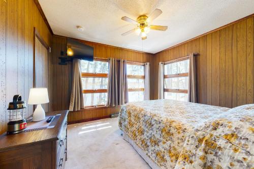 a bedroom with a bed and a ceiling fan at Let's Bay Together in Ossipee