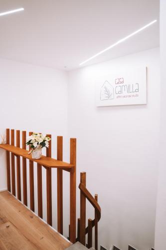 a staircase in a room with a sign on the wall at Casa Camilla in San Michele allʼAdige