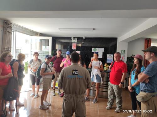 a group of people standing around in a kitchen at HOTEL D'PIERO MARCONA in San Juan de Marcona