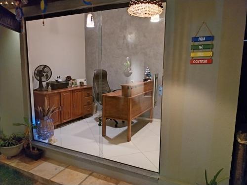 an office with a desk and a glass wall at Pousada Gostoso Village in São Miguel do Gostoso