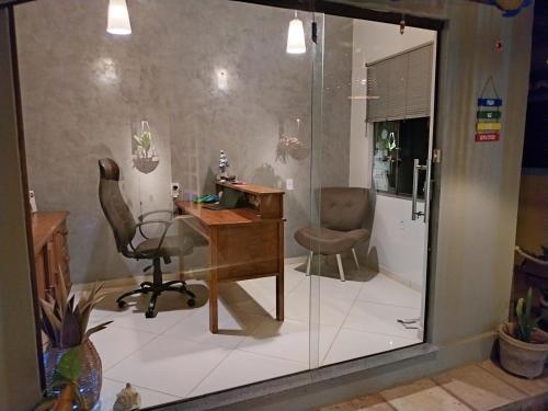 an office with a desk and a chair and a table at Pousada Gostoso Village in São Miguel do Gostoso