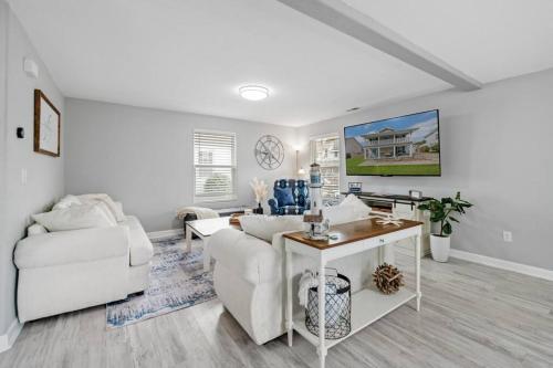 a living room with a white couch and a table at The Chesapeake St Retreat - Pet and Kid Friendly in Norfolk