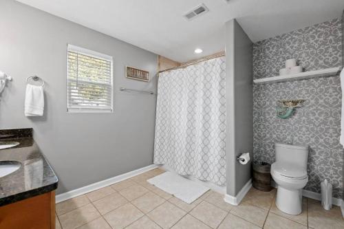 a bathroom with a toilet and a shower at The Chesapeake St Retreat - Pet and Kid Friendly in Norfolk