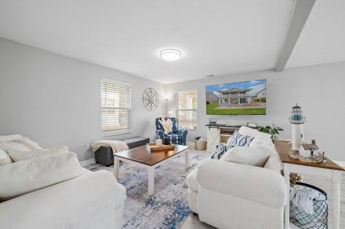 a living room with two white couches and a table at The Chesapeake St Retreat - Pet and Kid Friendly in Norfolk