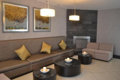 a living room with a couch and two tables at Hotel Jose Antonio in Lima