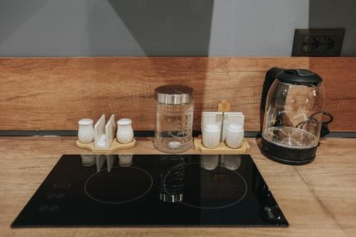 a counter top with a coffee maker and a blender at B.G Luxury Suites in Korçë
