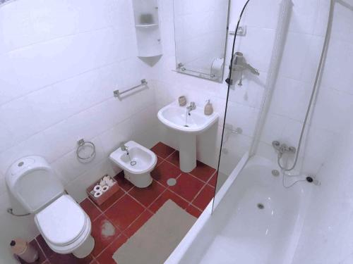 a bathroom with a toilet and a sink and a shower at Abrigo das Matas in Porto Santo