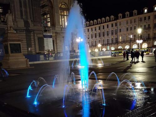 a water fountain in the middle of a city at night at B&B casa Liliana in Turin