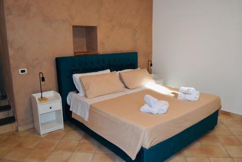 a bedroom with a bed with two towels on it at Casa Vacanze Vicolo Palaù in Trecastagni