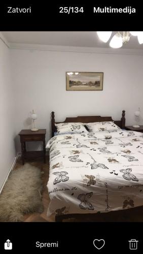 a bedroom with a bed with a comforter on it at Milja Goč in Kraljevo