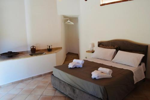 a bedroom with a large bed with towels on it at Casa Vacanze Vicolo Palaù in Trecastagni
