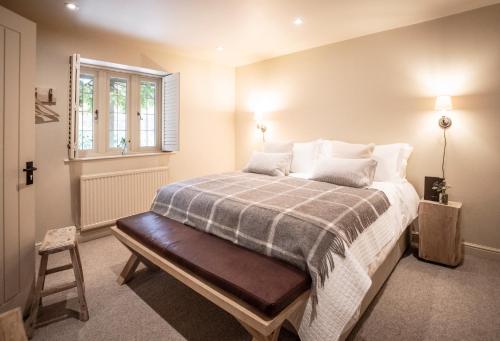 a bedroom with a bed and a window at The Three Horseshoes in Burford