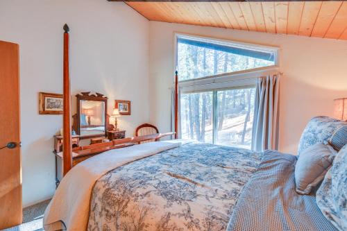 a bedroom with a bed and a large window at Munds Park Cabin with Deck and Golf Course Views in Munds Park