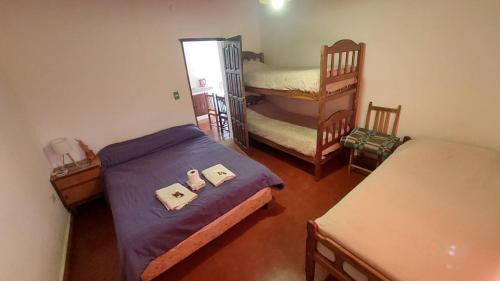 a bedroom with two beds and a bunk bed at Cabañas Tierra Andina in Tilcara