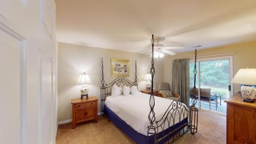 a bedroom with a bed with a wrought iron frame at Spacious 3BR Villa Groups of Six in Pawleys Island in Pawleys Island