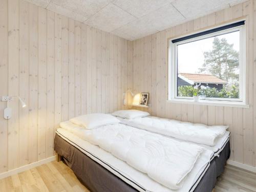a large bed in a room with a window at Modern Oasis in Marielyst - By Traum Ferienwohnungen in Marielyst