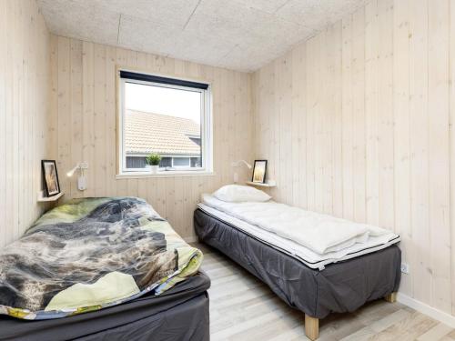 a bedroom with two beds and a window at Modern Oasis in Marielyst - By Traum Ferienwohnungen in Marielyst