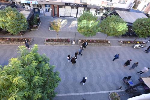 a group of people walking around a courtyard at Korzo Prenoćište in Novi Pazar