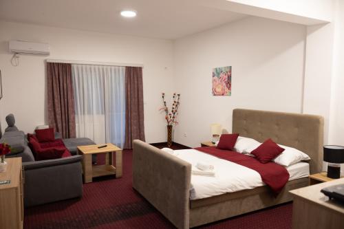 a hotel room with a bed and a couch at Hotel Muška voda in Kladanj