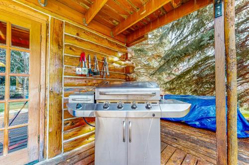 a kitchen with a stove and a sink in a cabin at Sawtooth Serenity in Hailey