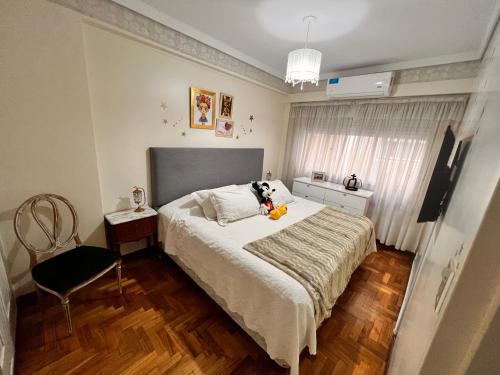 a bedroom with a bed with a stuffed animal on it at Apartamento Belgrano in Buenos Aires
