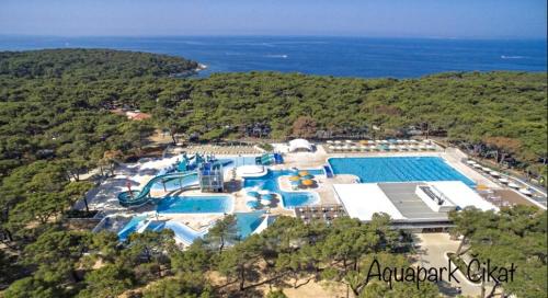 an aerial view of a resort with a swimming pool at Beautiful view apartment with garage space in Mali Lošinj