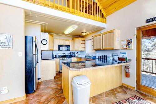 a kitchen with wooden cabinets and a counter top at Peter's Place in Angel Fire