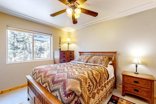 a bedroom with a bed and a ceiling fan at Peter's Place in Angel Fire