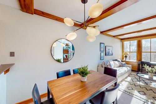 a dining room with a table and a couch at Palmyra 4E in Telluride