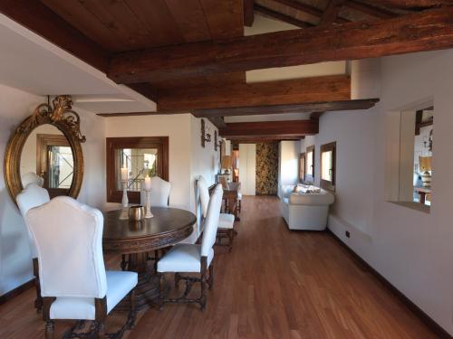 a dining room with a wooden table and white chairs at LaLux Venezia in Venice