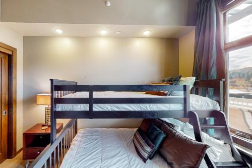 two bunk beds in a room with a window at Howelsen Panoramic Views in Steamboat Springs