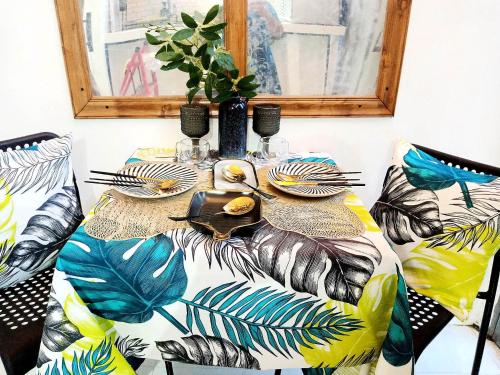 a table with a table cloth with tropical leaves at Dolores Residences Sean's Flat in General Santos