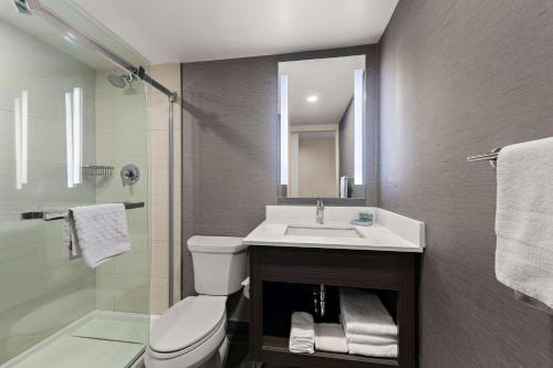 a bathroom with a sink and a toilet and a shower at Best Western Parkway Hotel Toronto North in Richmond Hill