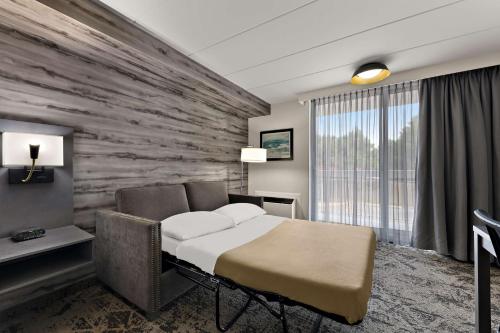 a hotel room with a bed and a stone wall at Best Western Parkway Hotel Toronto North in Richmond Hill
