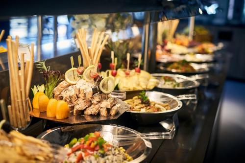 a buffet line with many different types of food at Corendon Apartments Amsterdam Schiphol Airport in Badhoevedorp