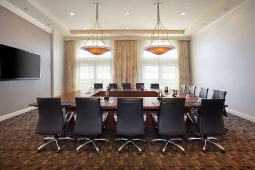 a conference room with a large table and chairs at Hilton Naples in Naples