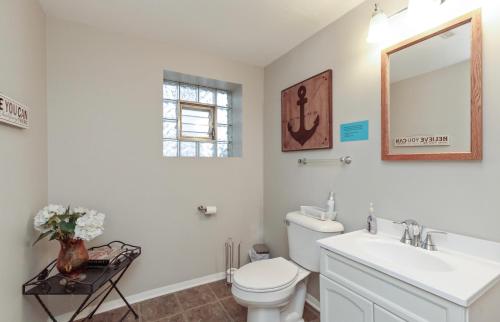 a bathroom with a toilet and a sink and a mirror at IVP Manor House By LAKE BEACH and NAVAL BASE in Gages Lake