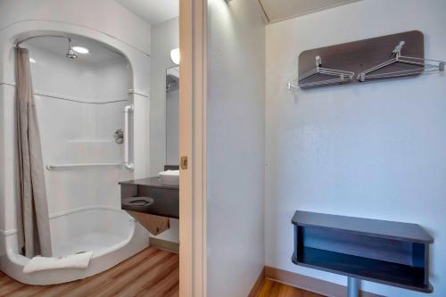 a bathroom with a shower and a sink and a toilet at Motel 6-Farmington, NM in Farmington