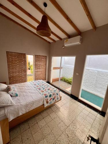 a bedroom with a bed and a view of the ocean at Colonial Beach Airport Hotel in Cartagena de Indias