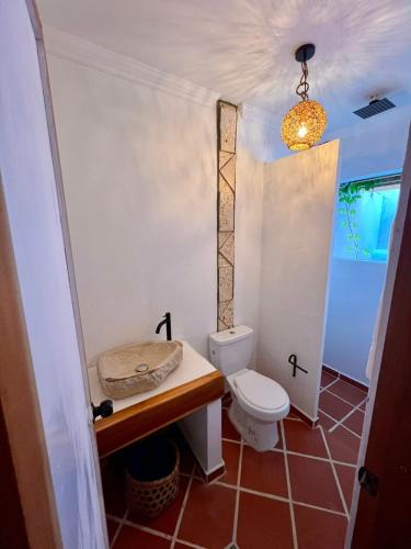 a bathroom with a toilet and a sink at Colonial Beach Airport Hotel in Cartagena de Indias